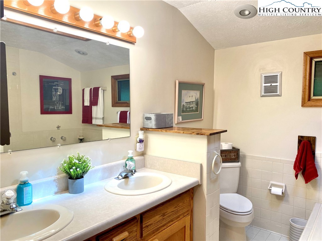 175 Ash Loop Newland, NC 28657 - Photo 26 of 46 a bathroom with a granite countertop sink and a mirror