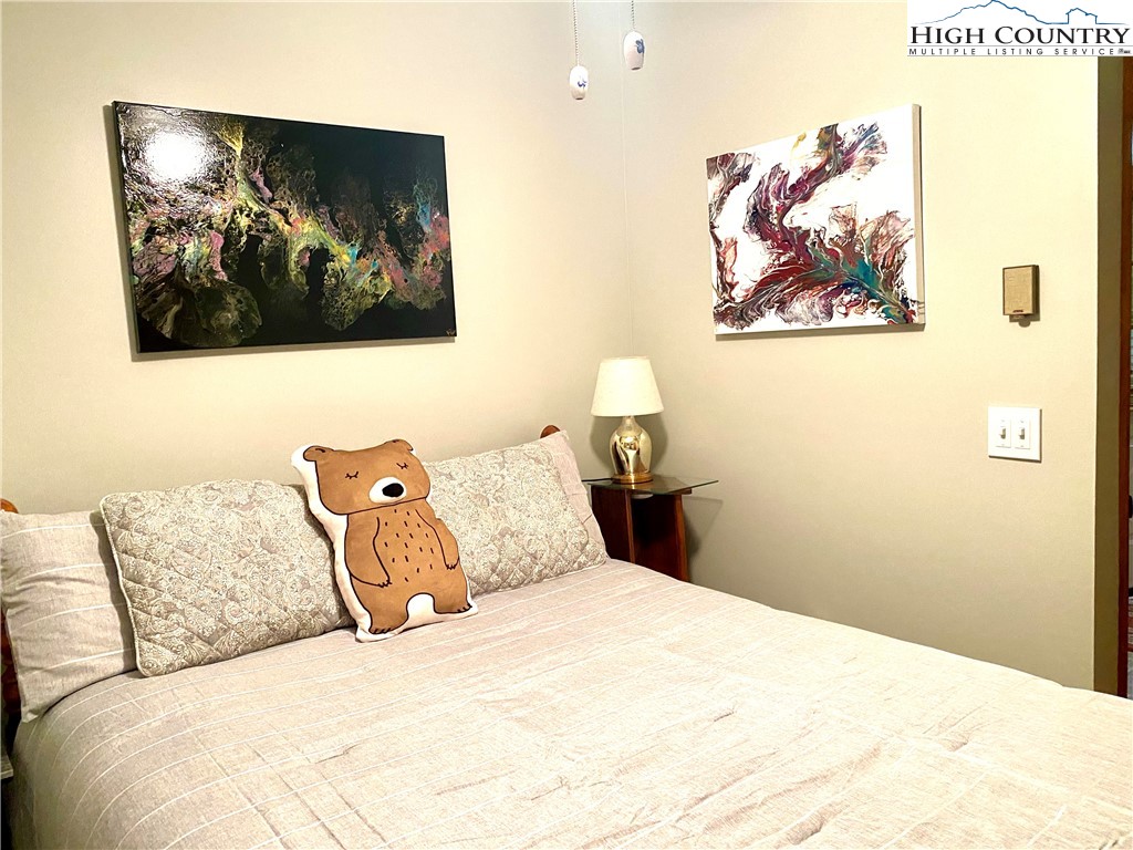 175 Ash Loop Newland, NC 28657 - Photo 28 of 46 a bedroom with a bed and painting on the wall