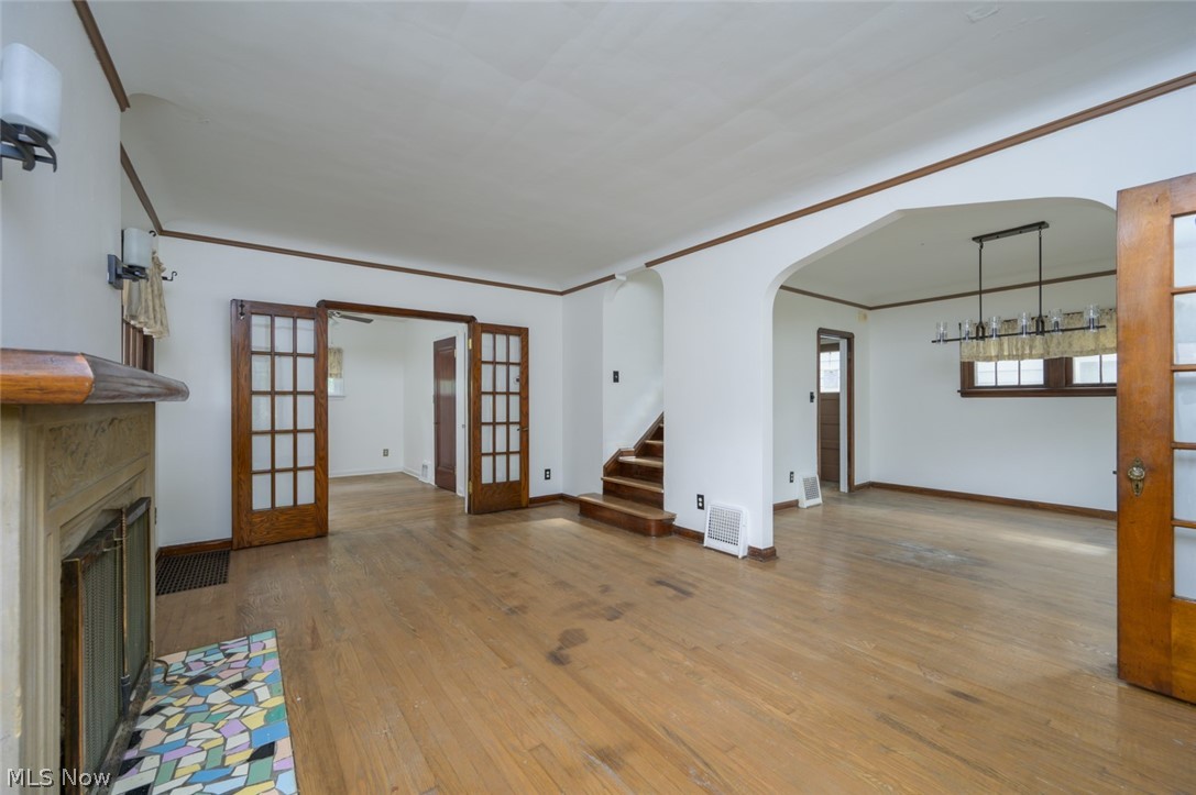 3869 Montevista Road Cleveland, OH 44121 - Photo 6 of 43 Unfurnished living room with wood-type flooring, french doors, and crown molding