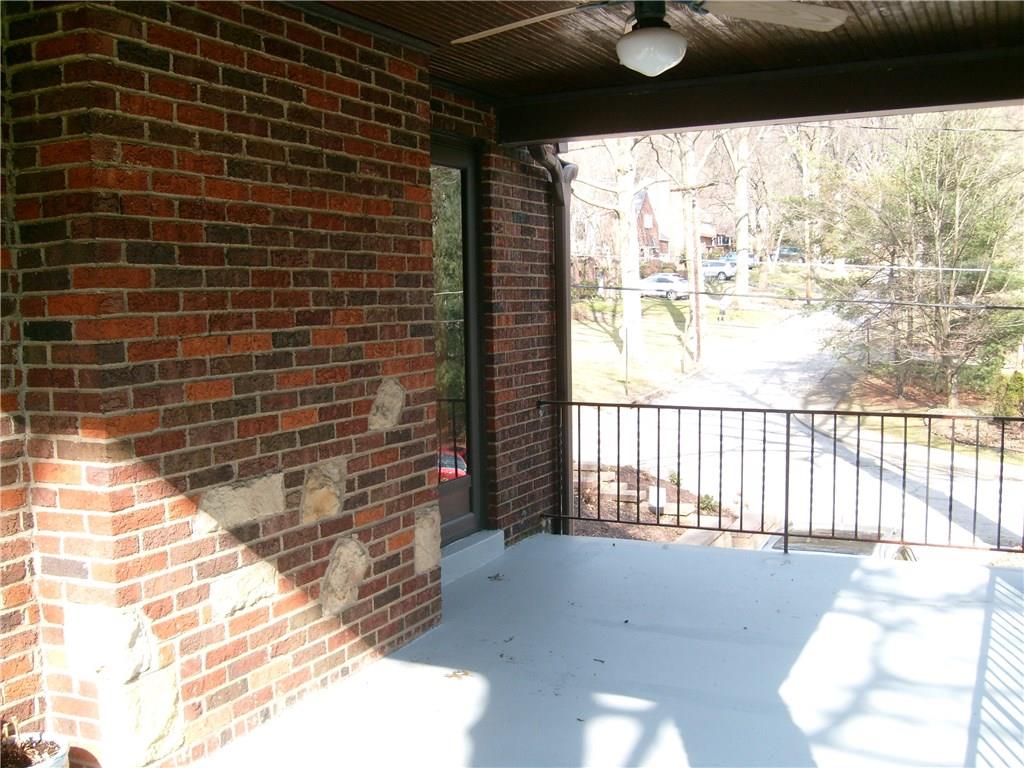 220 Cascade Road Forest Hills, PA 15221 - Photo 23 of 25 Side porch with entrance into living room. Interesting brick & stone work, wood ceiling, and ceiling fan.