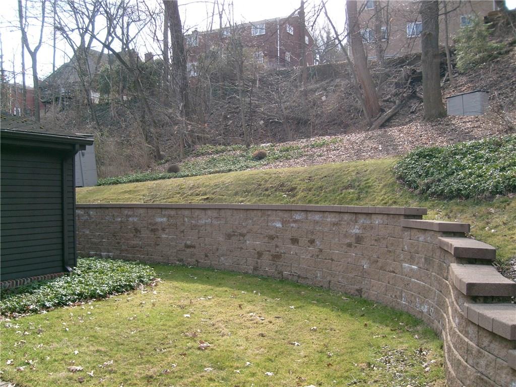 220 Cascade Road Forest Hills, PA 15221 - Photo 24 of 25 Magnificent retaining wall surrounding lovely grassy area for entertaining. Entrance to small hallway from here with access to kitchen and master bedroom. Retaining wall just recently power washed.