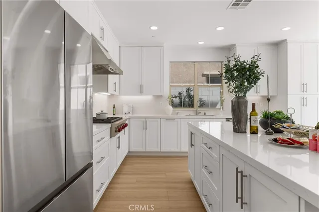 a view of a hallway with furniture and a potted plant