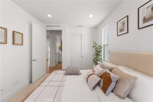 a view of a hallway with wooden floor and entryway