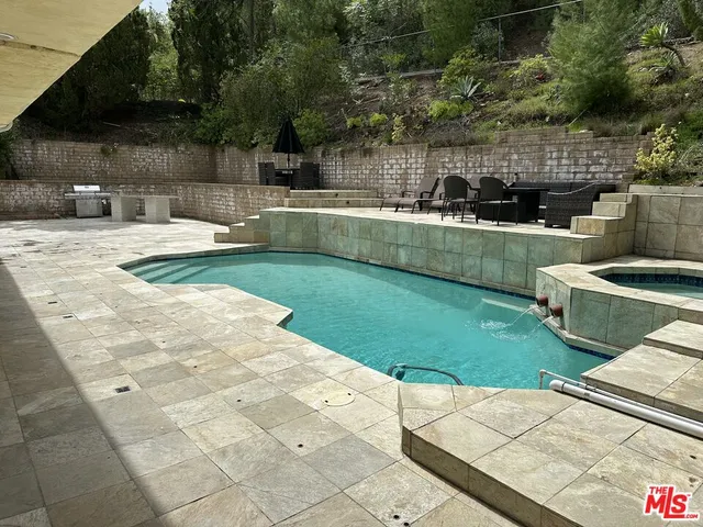 a view of house with backyard outdoor seating and green space