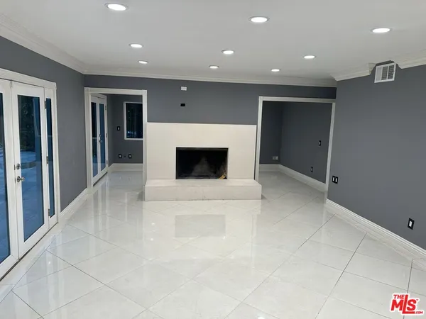 a view of an empty room with a fireplace
