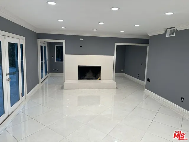 a view of an empty room with a fireplace