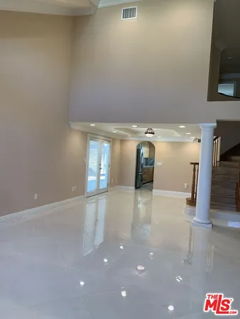 a large kitchen with a large counter top stainless steel appliances and cabinets