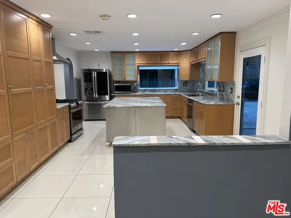 a kitchen with stainless steel appliances a refrigerator and a sink