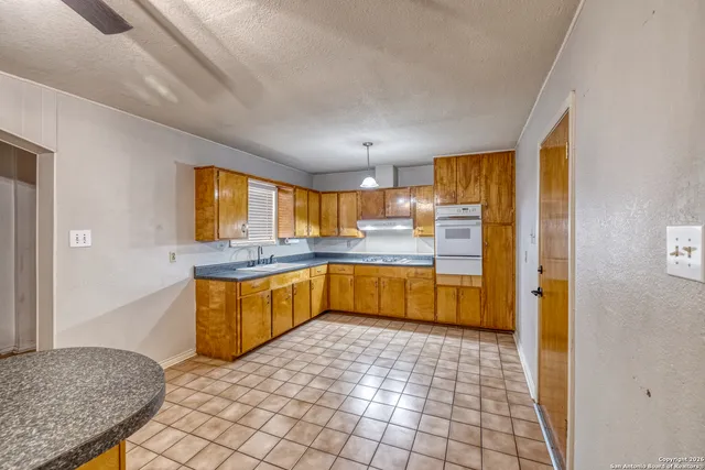 a kitchen with stainless steel appliances granite countertop a sink and cabinets