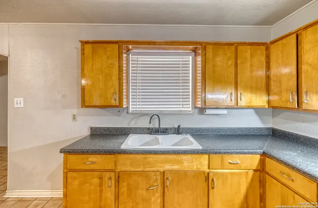 a kitchen with a sink and a window