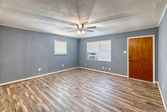 wooden floor in an empty room with a window