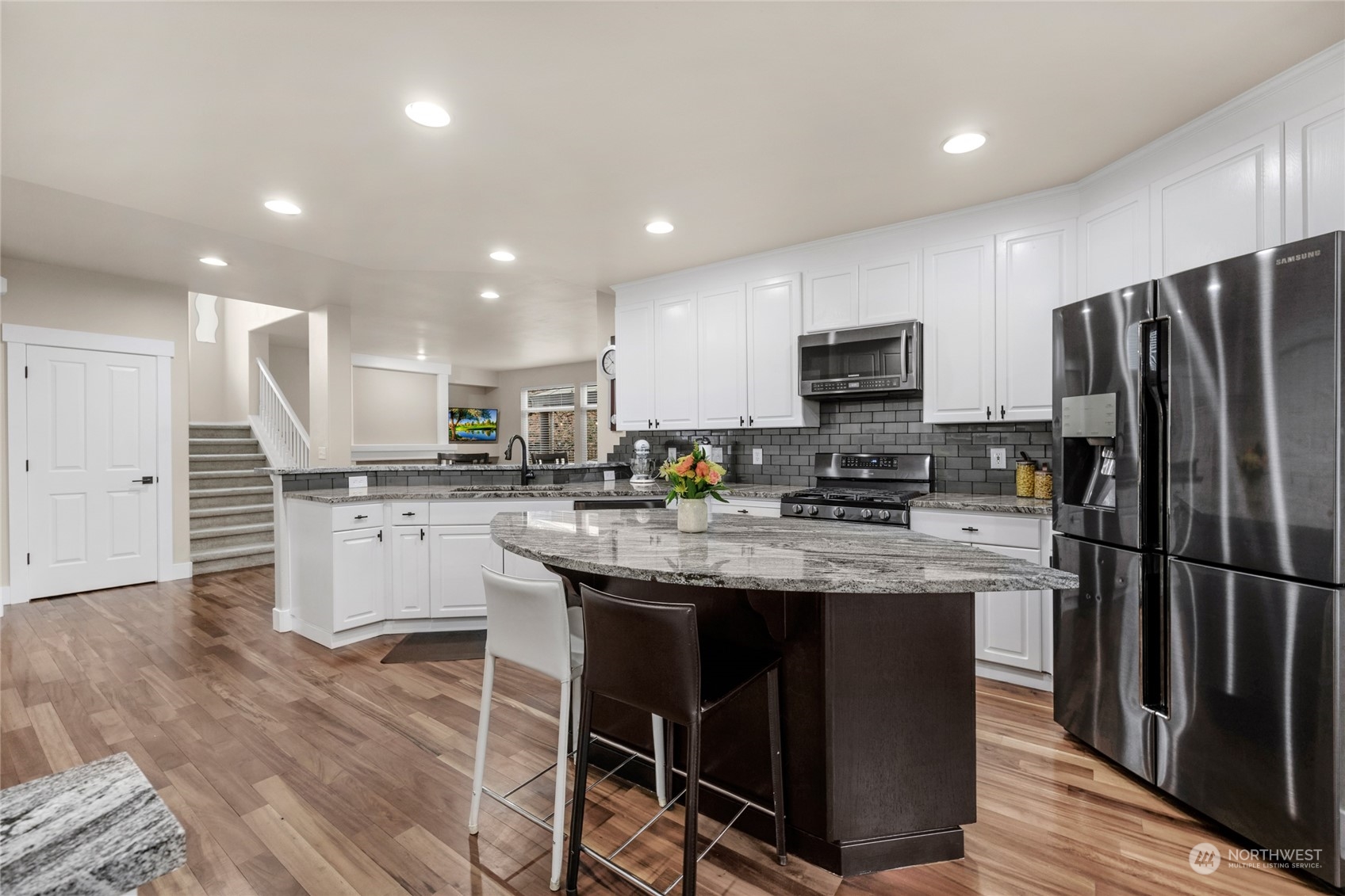 18712 33rd Avenue Southeast Bothell, WA 98012 - Photo 15 of 39 a kitchen with stainless steel appliances granite countertop a sink refrigerator and microwave