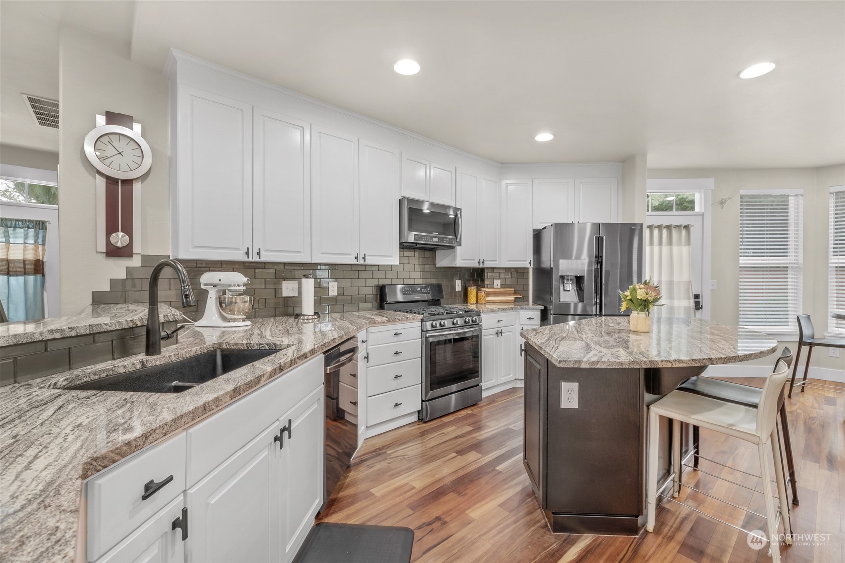 18712 33rd Avenue Southeast Bothell, WA 98012 - Photo 16 of 39 a kitchen with granite countertop a sink appliances cabinets and furniture