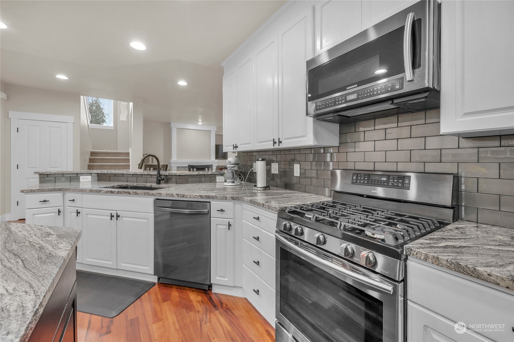 18712 33rd Avenue Southeast Bothell, WA 98012 - Photo 18 of 39 a kitchen with stainless steel appliances granite countertop a stove microwave and cabinets
