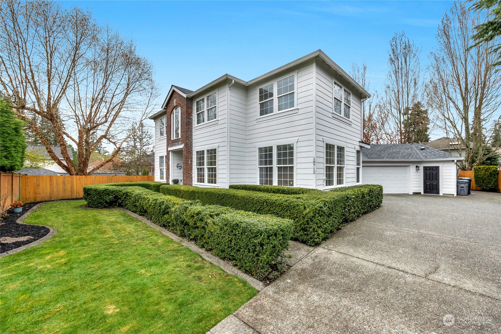 18712 33rd Avenue Southeast Bothell, WA 98012 - Photo 2 of 39 a front view of a house with a yard and garage
