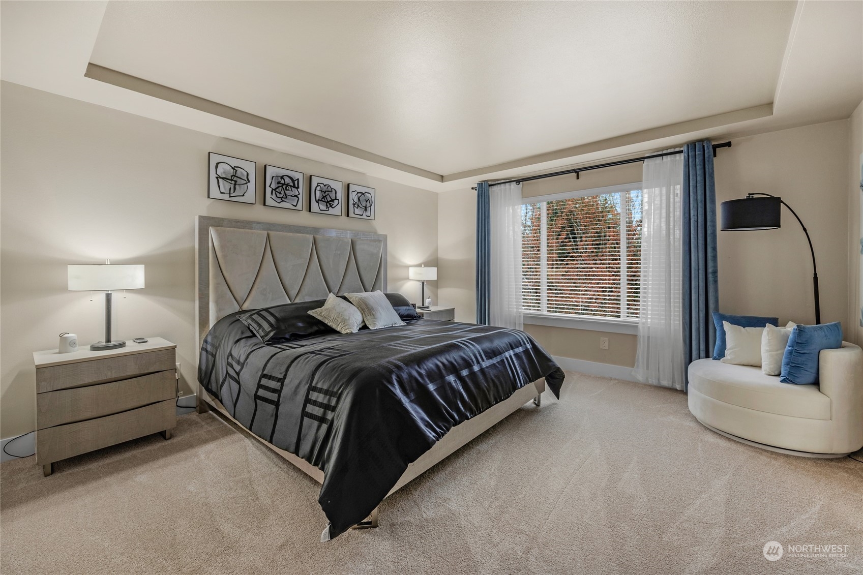 18712 33rd Avenue Southeast Bothell, WA 98012 - Photo 23 of 39 a spacious bedroom with a bed a couch and a window