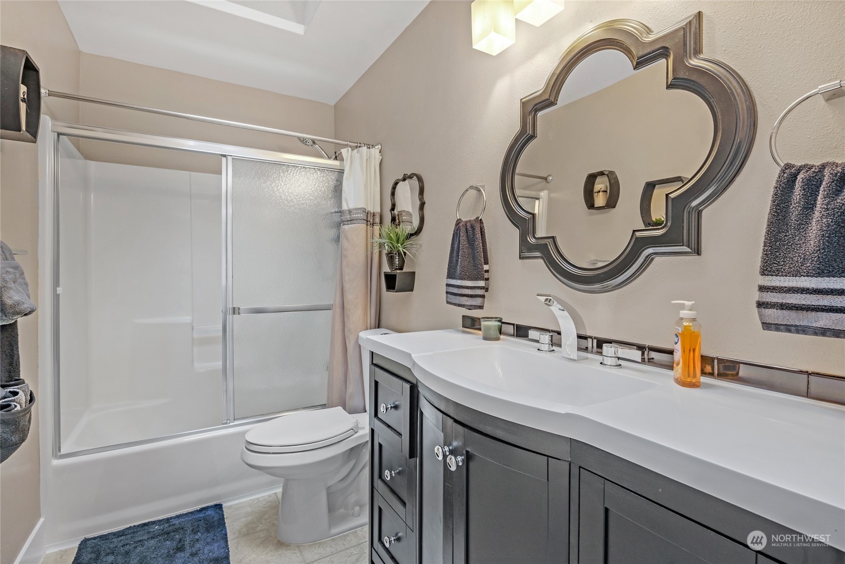 18712 33rd Avenue Southeast Bothell, WA 98012 - Photo 29 of 39 a bathroom with a sink mirror vanity and toilet
