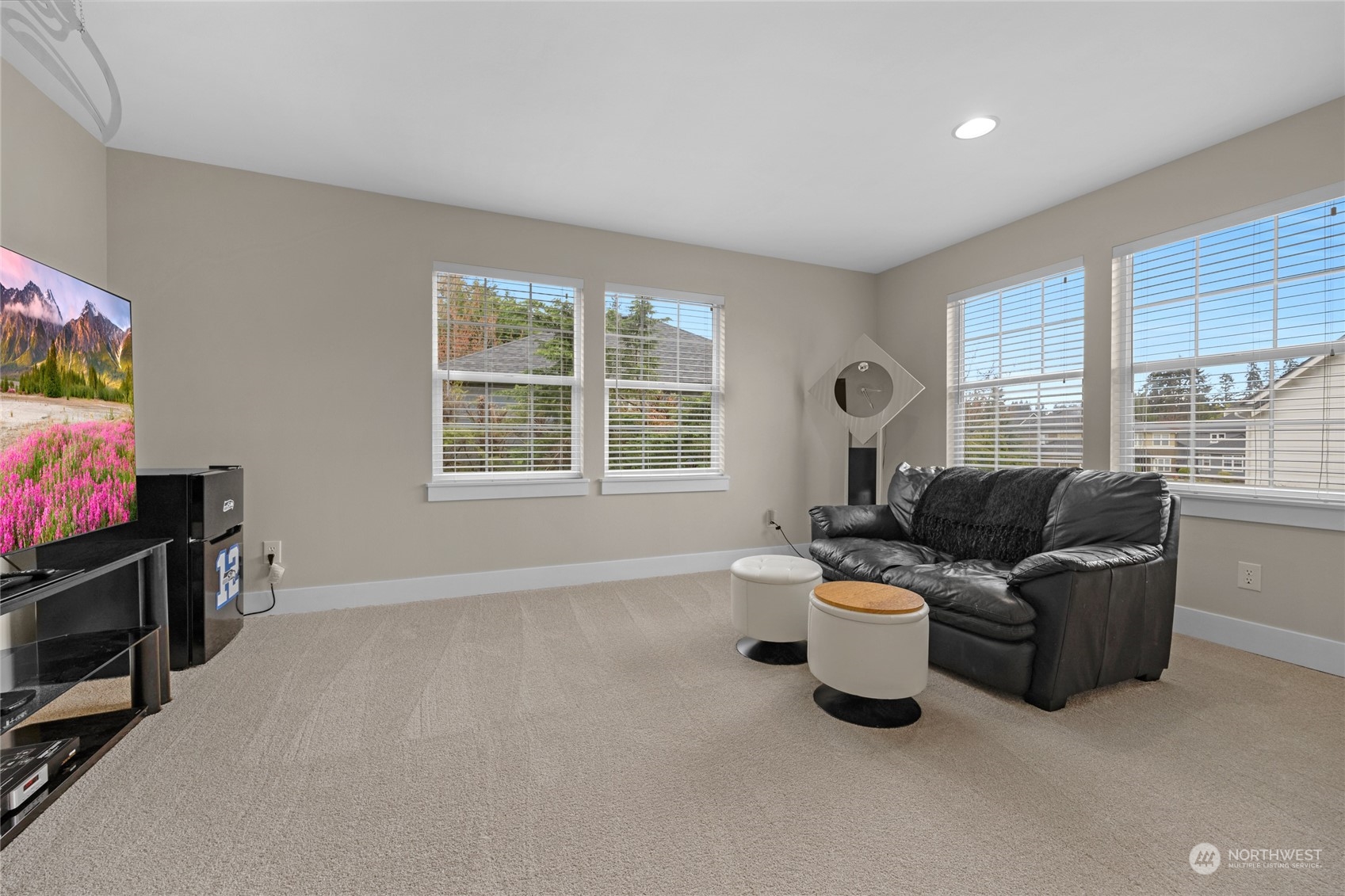 18712 33rd Avenue Southeast Bothell, WA 98012 - Photo 32 of 39 a living room with furniture a flat screen tv and windows