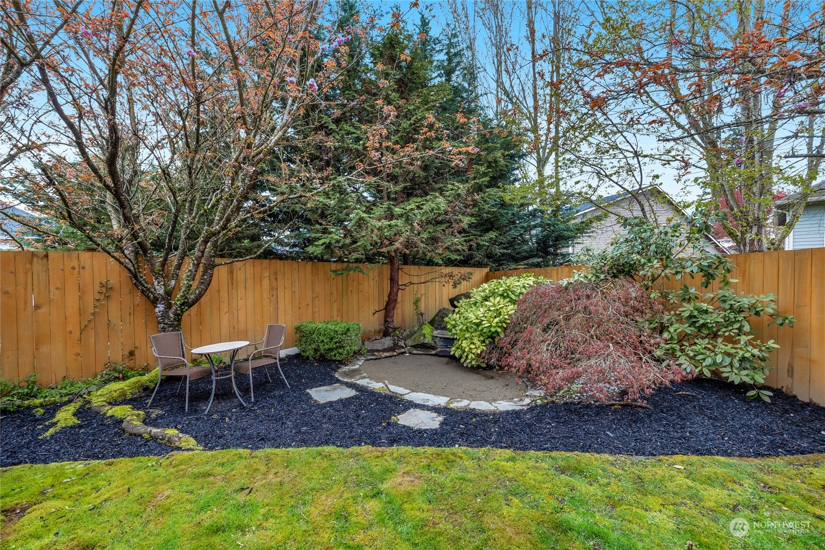 18712 33rd Avenue Southeast Bothell, WA 98012 - Photo 34 of 39 a view of a backyard with table and chairs potted plants and large tree