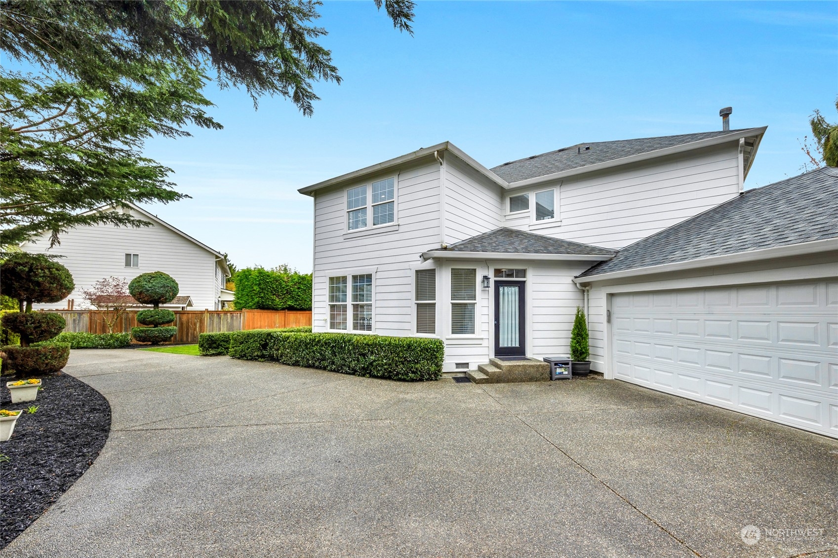 18712 33rd Avenue Southeast Bothell, WA 98012 - Photo 5 of 39 a front view of a house with a yard and garage