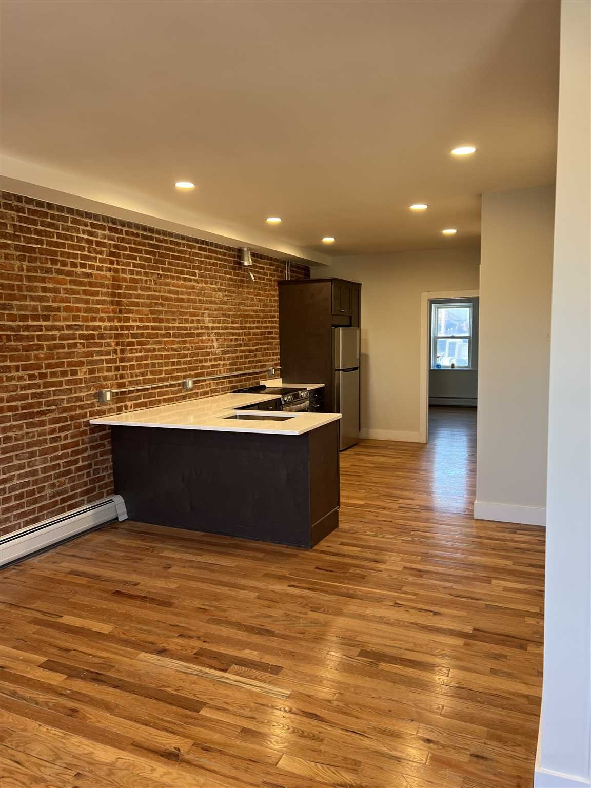 195 Main Street, Unit 2 Beacon, NY 12508 - Photo 2 of 8 a view of kitchen with stainless steel appliances wooden floor