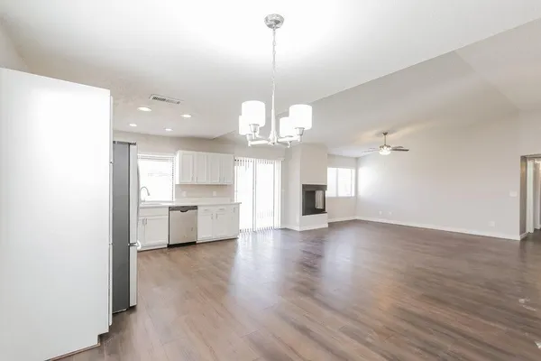 a view of a kitchen with a sink dishwasher a kitchen counter and cabinets