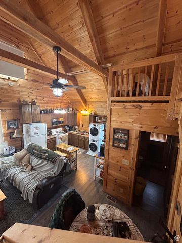 19075 West Honesty Cove Duchesne, UT 84021 - Photo 22 of 44 Open-concept living space with extensive wood paneling and exposed ceiling beams