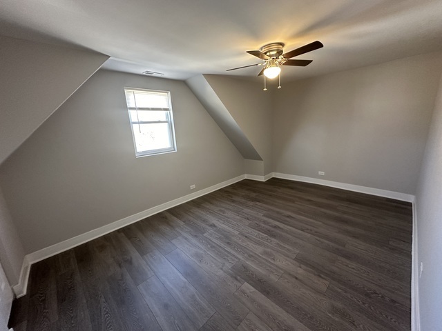 6924 South Aberdeen Street, Unit 2 Chicago, IL 60621 - Photo 3 of 10 wooden floor in an empty room with a window