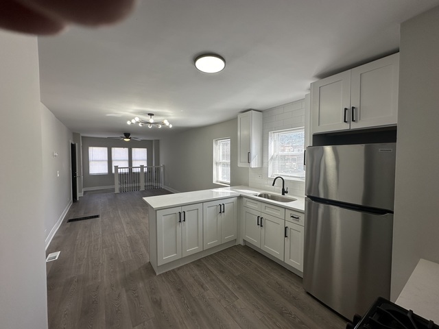 6924 South Aberdeen Street, Unit 2 Chicago, IL 60621 - Photo 9 of 10 a kitchen with a sink appliances and cabinets