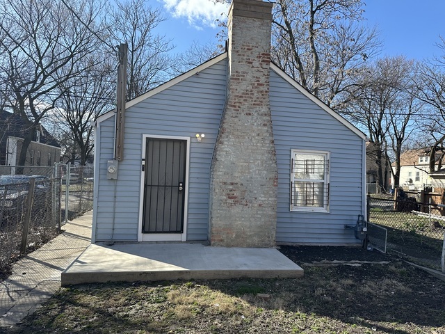 6924 South Aberdeen Street, Unit 2 Chicago, IL 60621 - Photo 10 of 10 a wooden bench sitting in front of a house