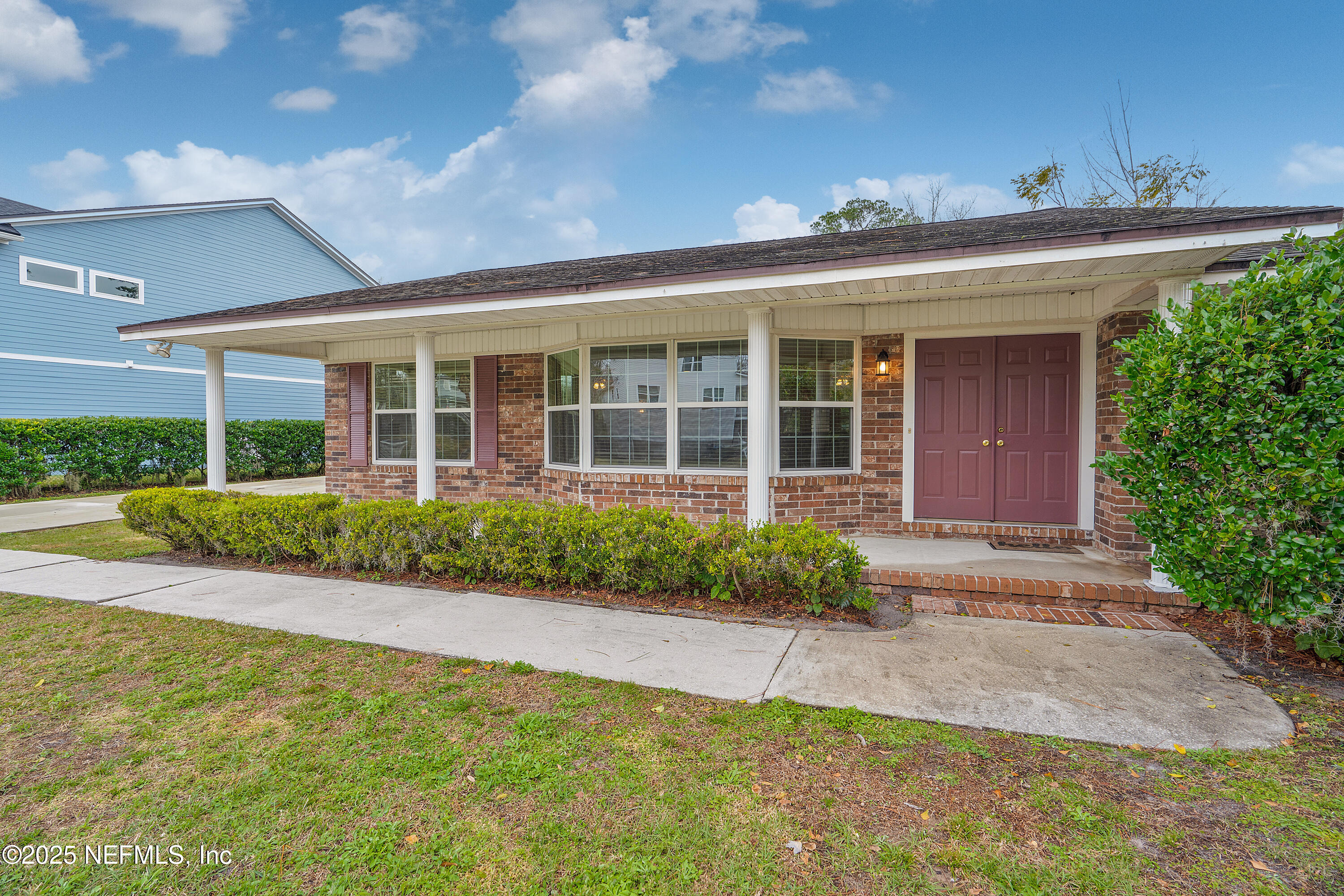 12932 Helm Drive Jacksonville, FL 32258 - Photo 13 of 42 a front view of a house with a yard and potted plants