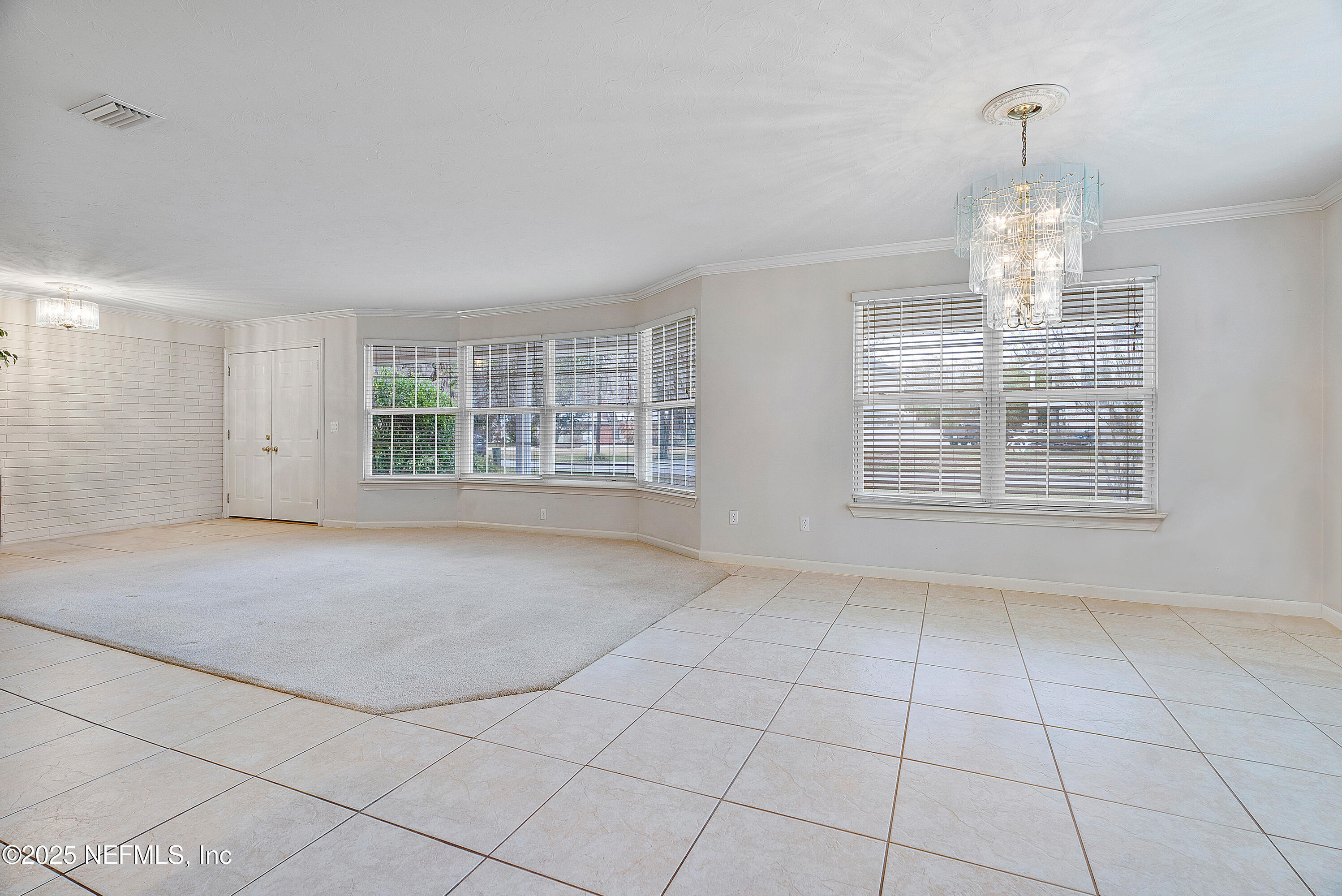 12932 Helm Drive Jacksonville, FL 32258 - Photo 15 of 42 an empty room with windows and entrance