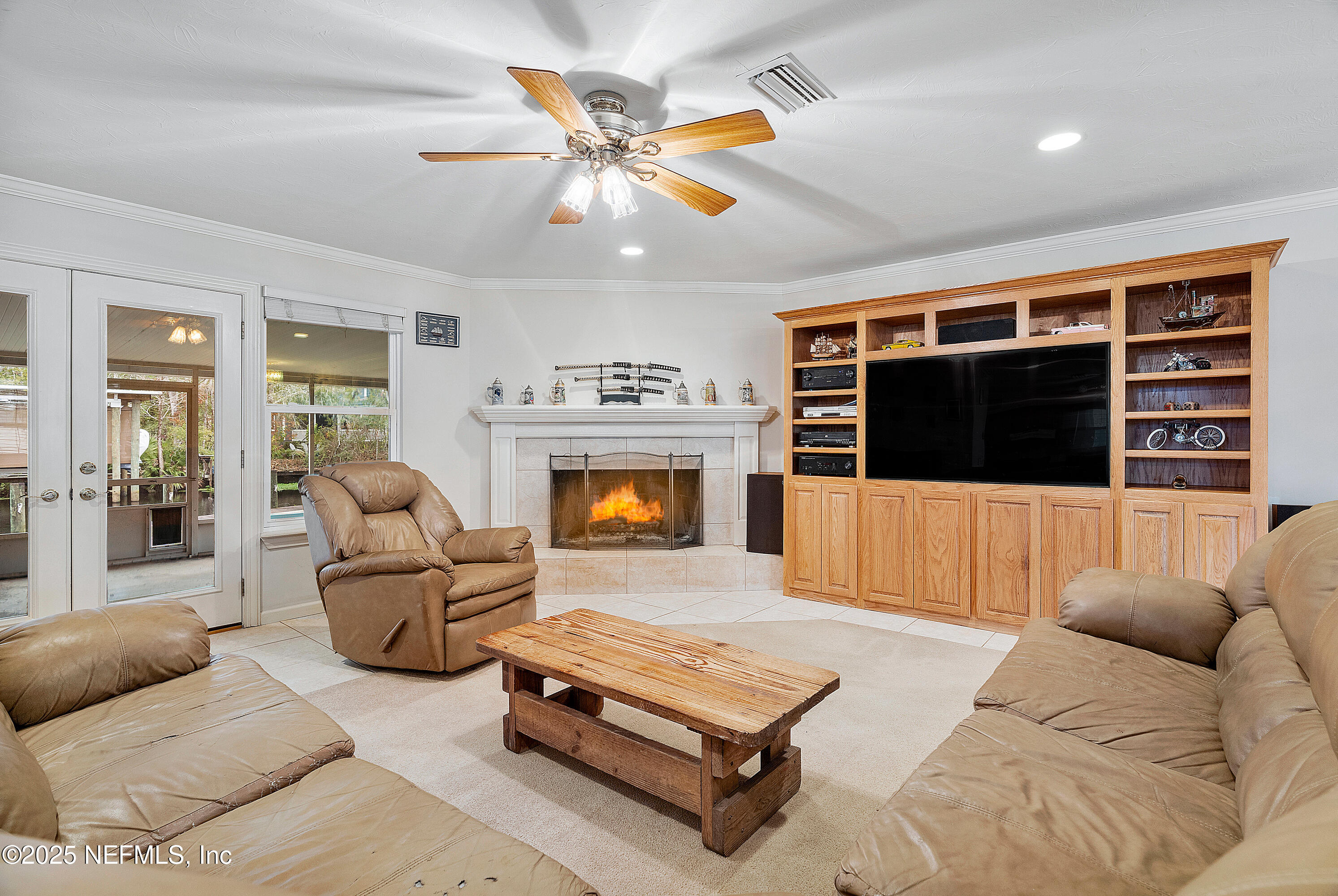 12932 Helm Drive Jacksonville, FL 32258 - Photo 20 of 42 a living room with furniture a flat screen tv and a fireplace
