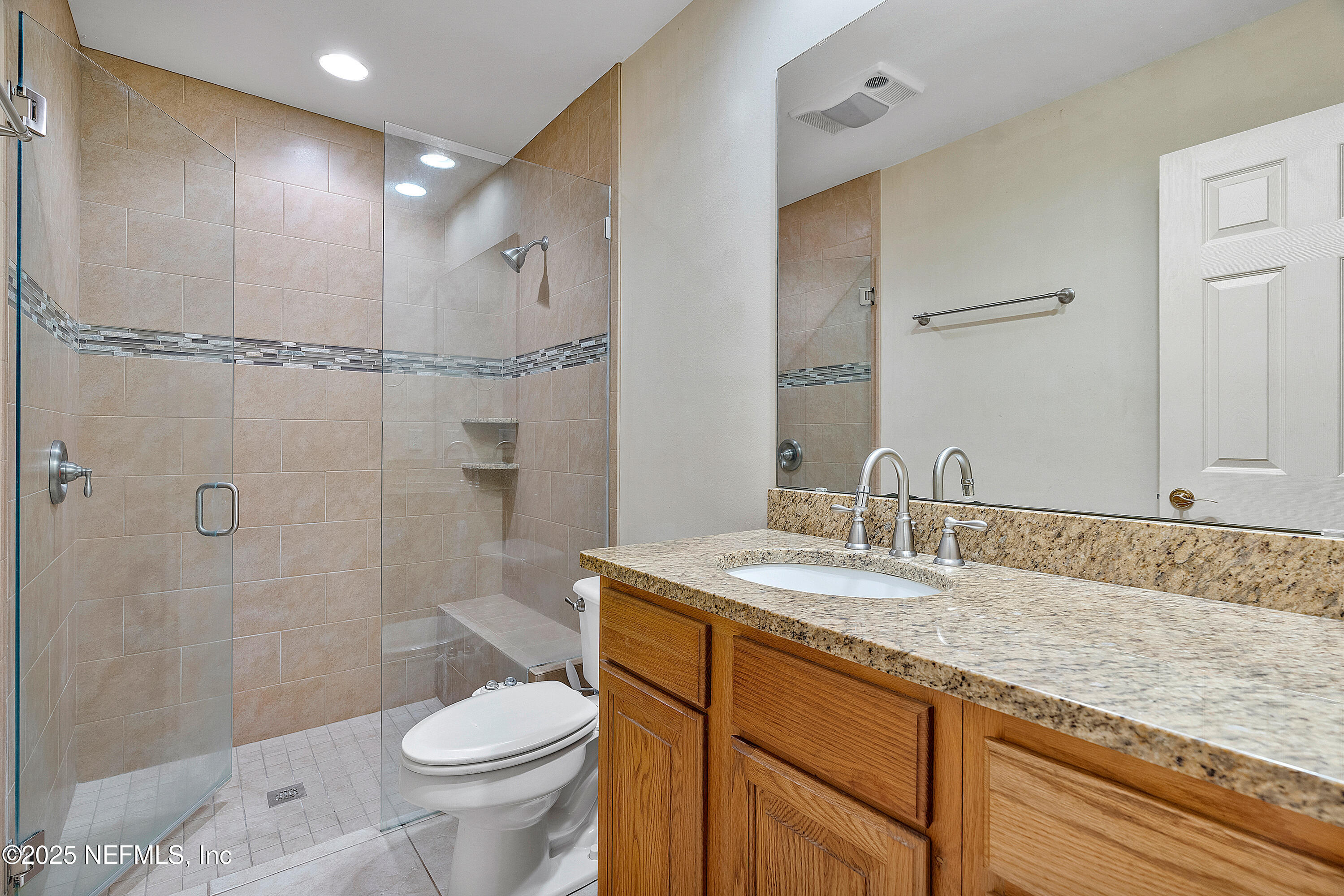 12932 Helm Drive Jacksonville, FL 32258 - Photo 23 of 42 a bathroom with a granite countertop sink toilet and shower