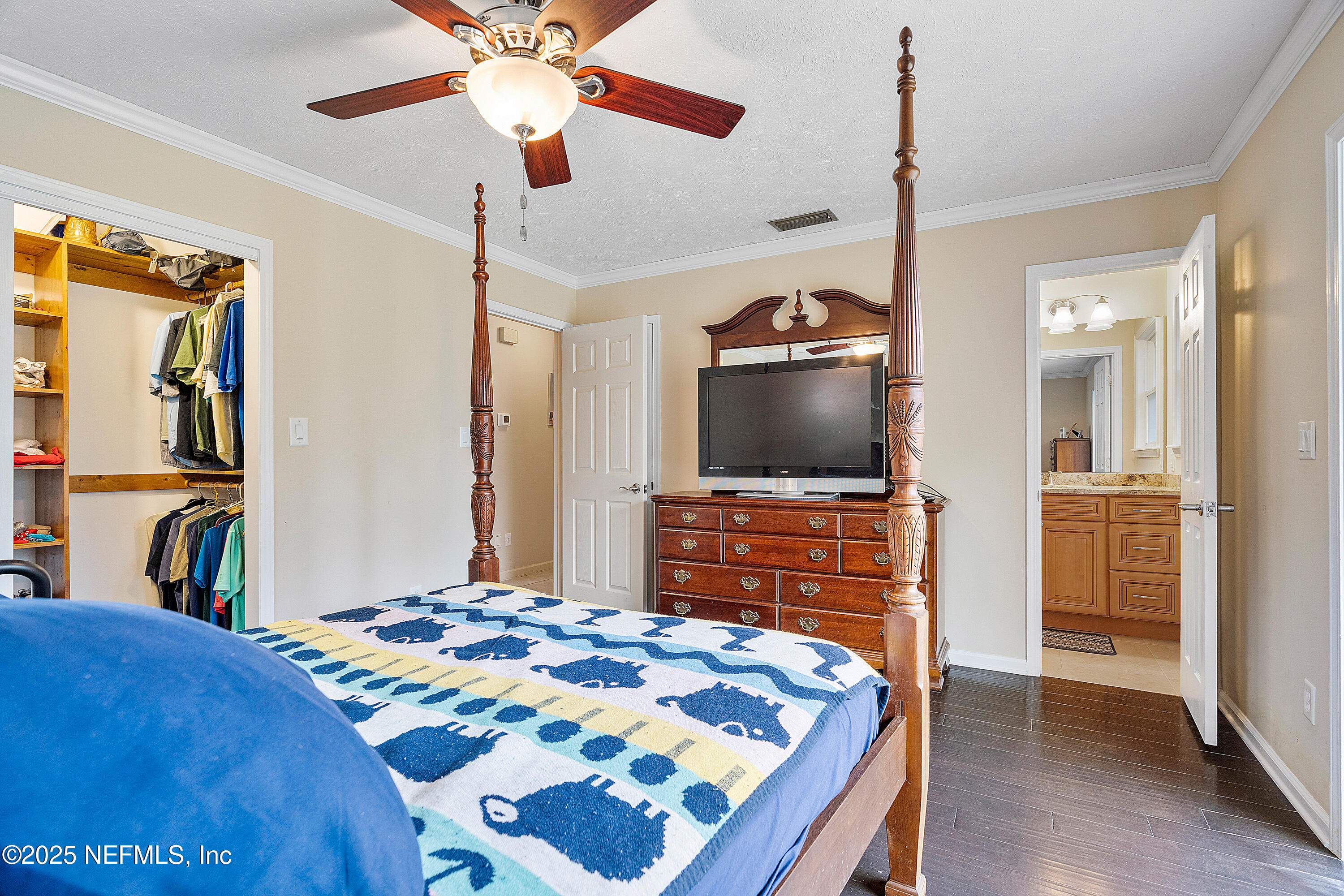 12932 Helm Drive Jacksonville, FL 32258 - Photo 24 of 42 a bedroom with a bed and a flat screen tv