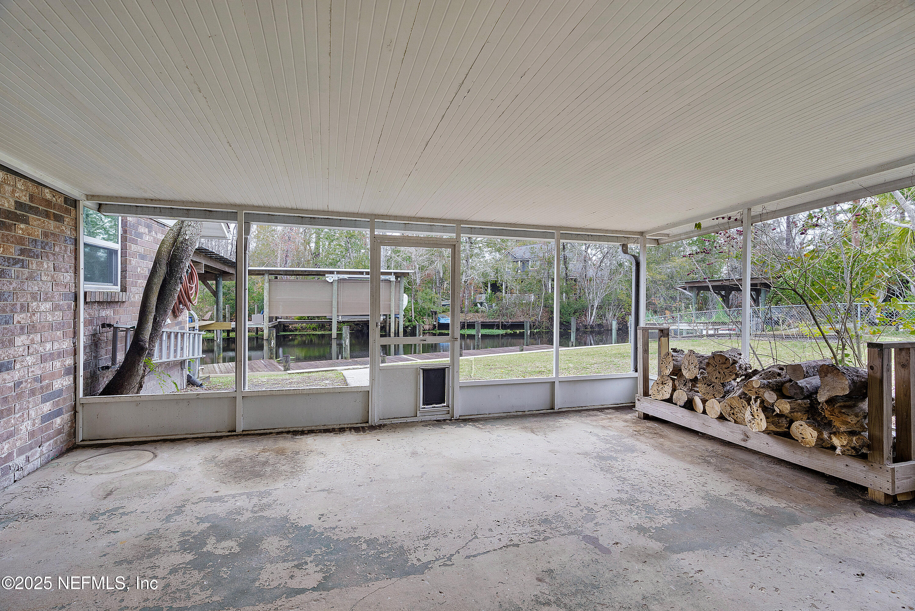 12932 Helm Drive Jacksonville, FL 32258 - Photo 9 of 42 a view of a big room with large windows and brick walls