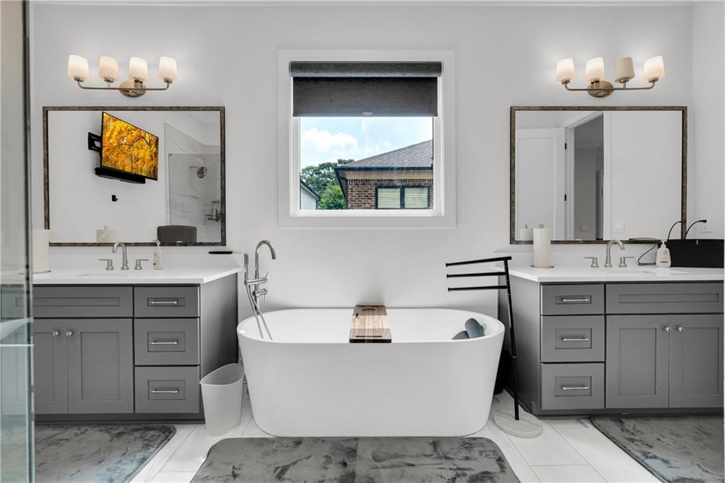 1141 Druid Fields Court Decatur, GA 30033 - Photo 15 of 35 a bathroom with a sink vanity granite tub and a mirror