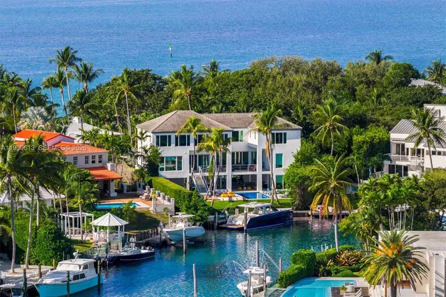 a backyard of a house with lots of green space and lake view