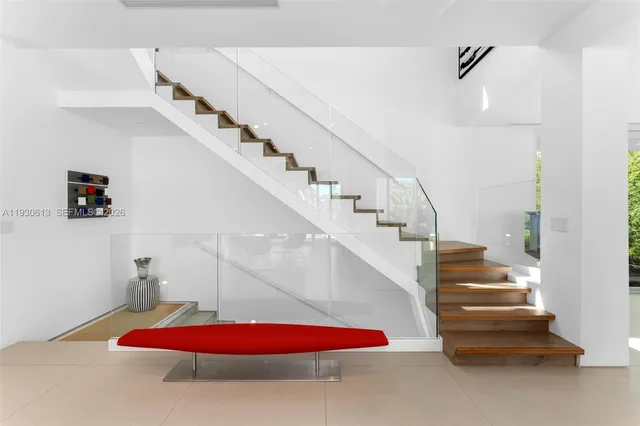 a living room with furniture and a stairs
