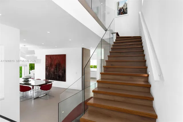 a large kitchen with stainless steel appliances granite countertop a sink and a refrigerator