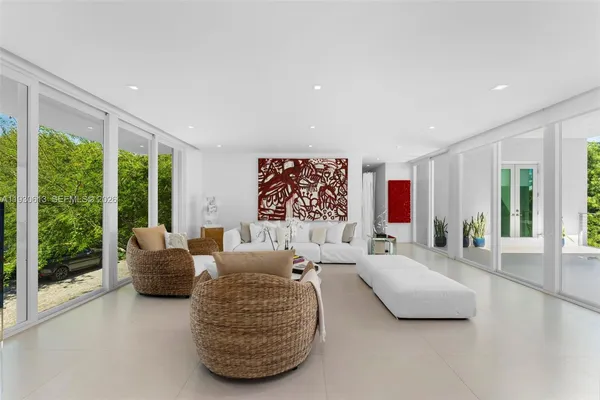 a living room with furniture and large windows