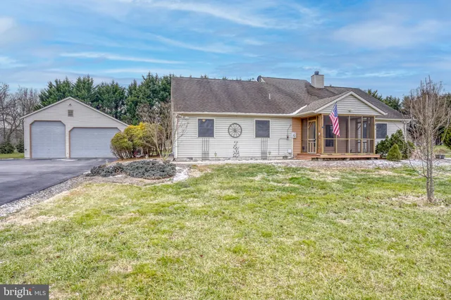 a view of a house with a yard patio and fire pit