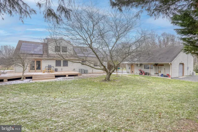 a view of a house with backyard and porch