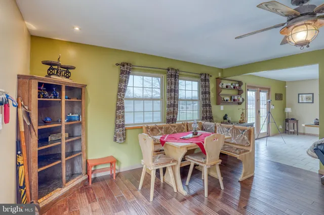 a kitchen with cabinets appliances and a dining table