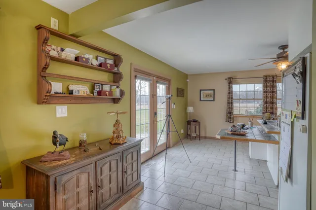 a kitchen with a sink a stove cabinets and a dining table