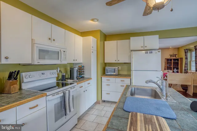 a spacious bathroom with a double vanity sink a mirror and a shower