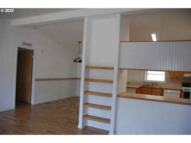 a kitchen with refrigerator cabinets and a sink