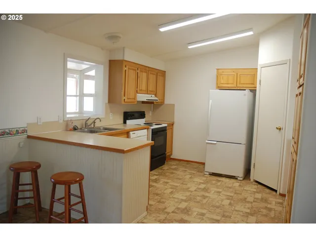 a kitchen with a refrigerator and cabinets