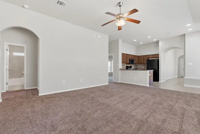 a view of a kitchen with a sink and a refrigerator
