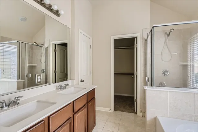 a bathroom with a double vanity sink mirror and shower